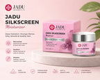 Jadu Silkscreen Moisturizer jar and its pink packaging box displayed on a light beige pedestal against a soft pink background with product features listed on the left.